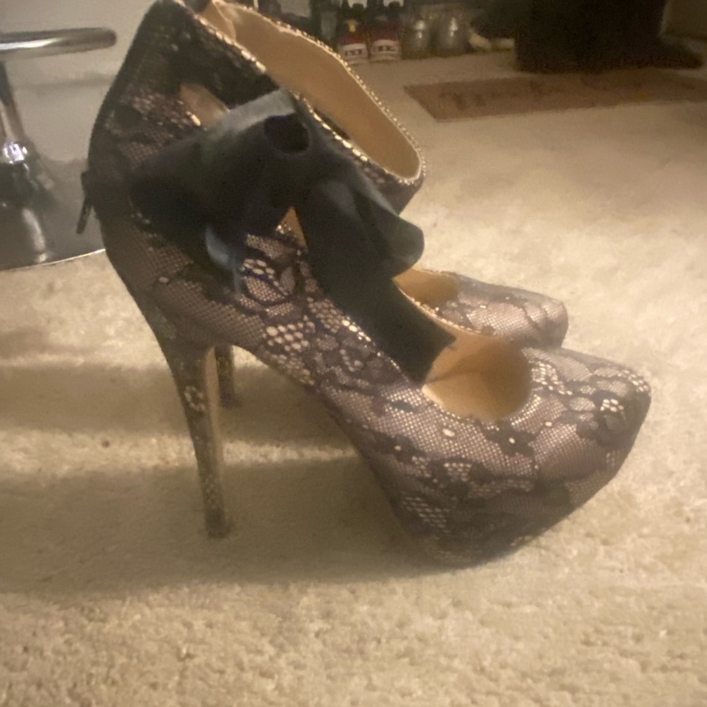 5’ black lace over nude, black bow ankle strap, slightly worn.